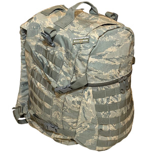 Camouflage backpack with multiple straps and a visible Grandpops Army Navy logo on a white background