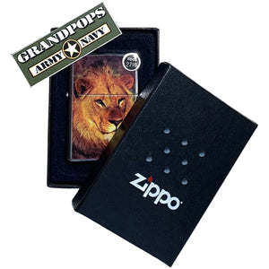 Zippo lighter with lion design in a black Zippo case on a textured surface, featuring a 'Grandpops Army Navy' logo.